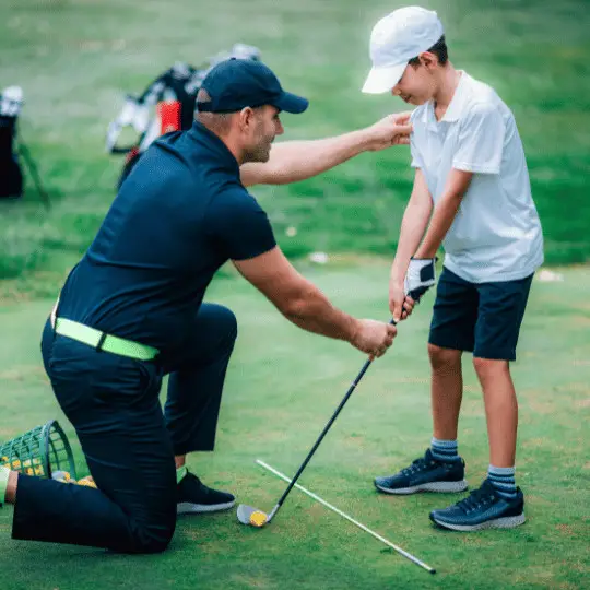 Golfer training young potential golfer