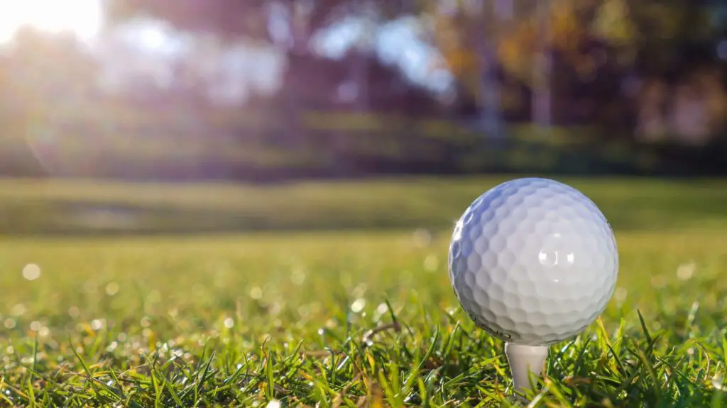 Golf ball on green golf course grass