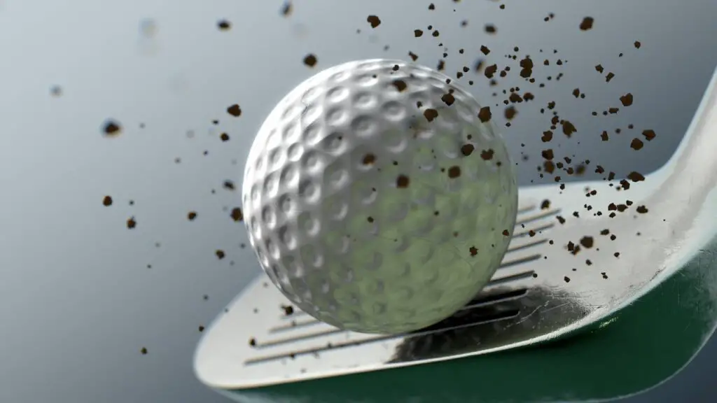 Golf wedge hitting golf ball with sand on it