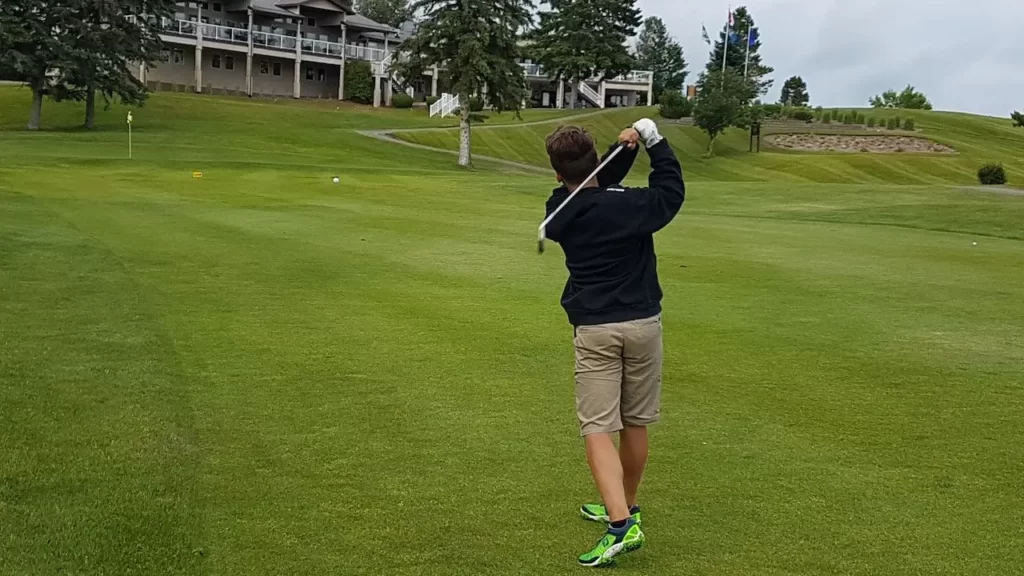 Golfer hitting shot on golf course