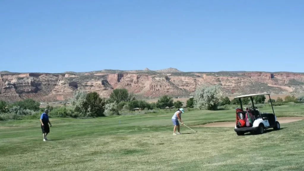Golfer hitting shot on golf green