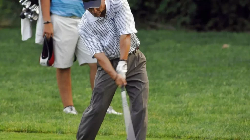 Golfer in moment of hitting golf shot