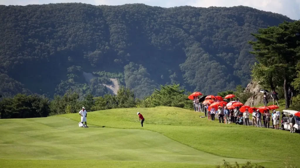 Spectators waiting for shot to be played on golf course