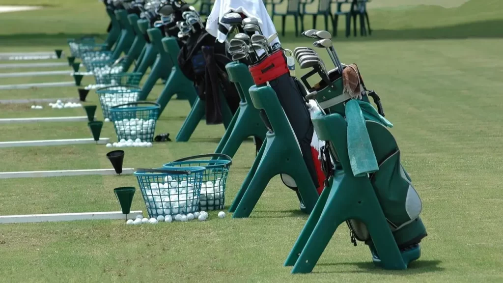 Clubs and balls lined up on a driving range