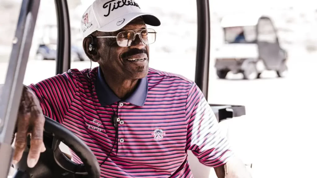 Golfer in Polo shirt sitting on golf cart