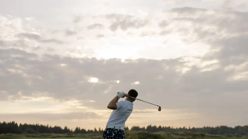 Golfer swinging on golf course