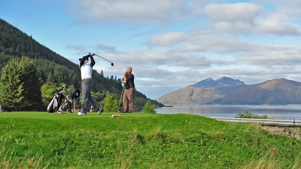 Golfer swinging shot in picturesque view