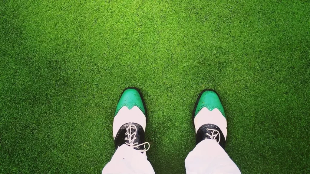 Green and white golf shoes from above