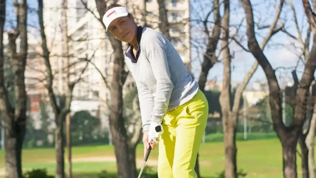 Women golfer lining up putt on golf course
