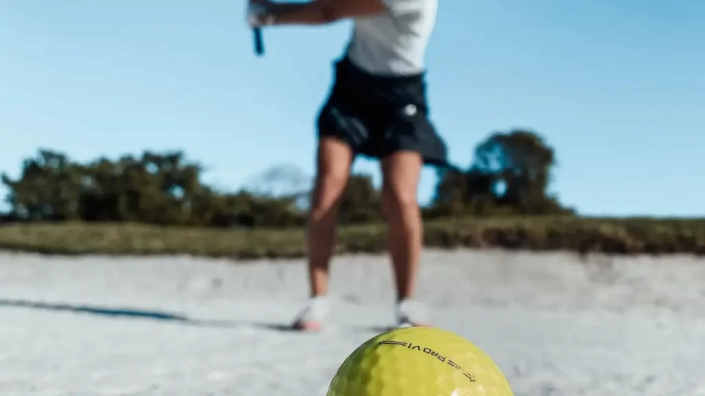 Women golfer practicing golf shot