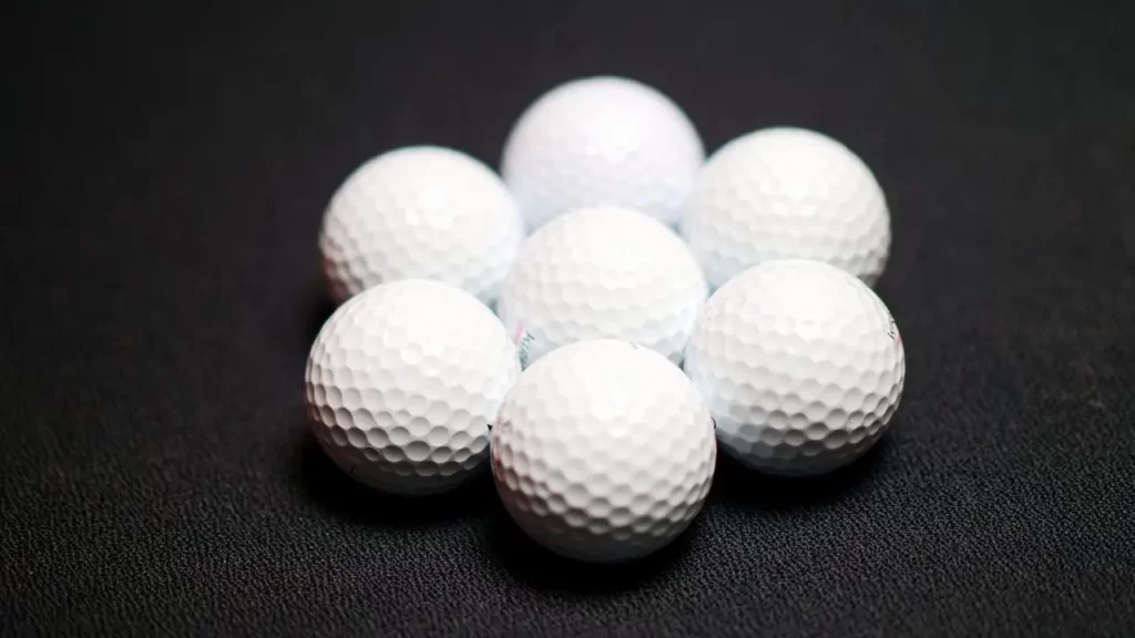 7 Golf balls lying on floor