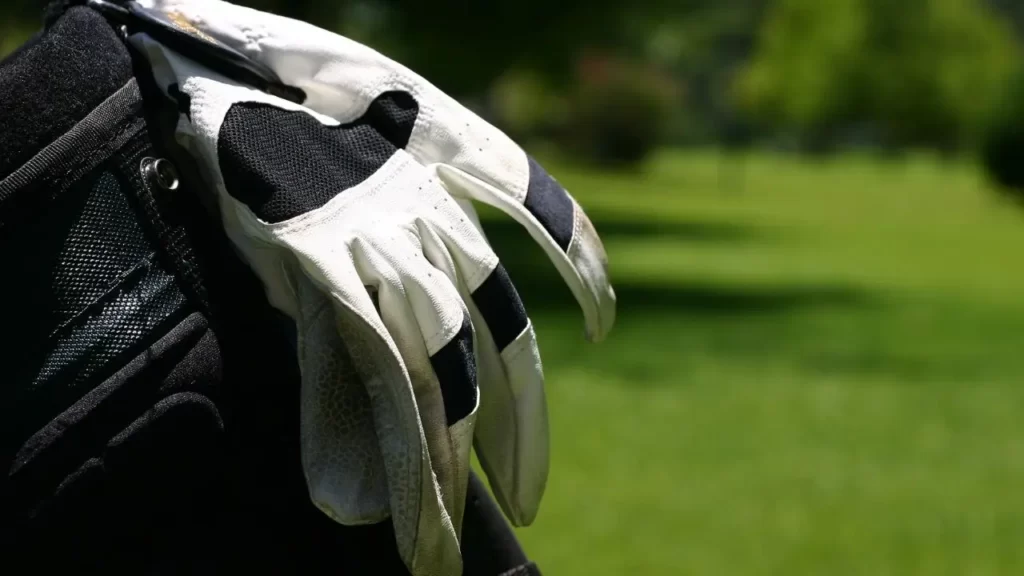 Golf gloves on caddy bag on golf course