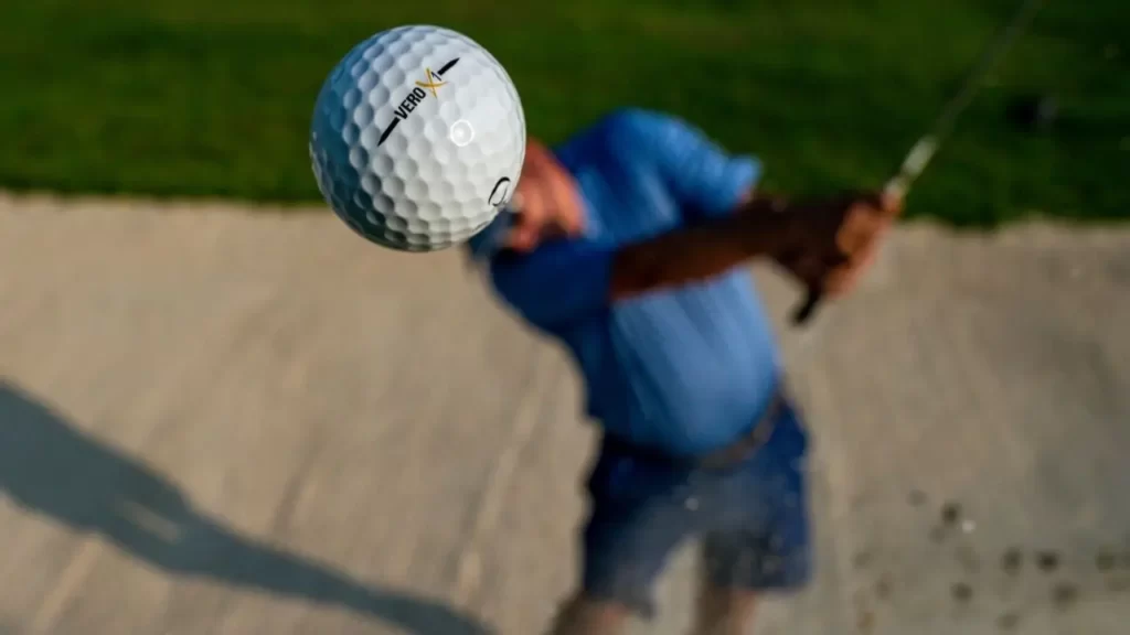 Golf hitting ball toward camera