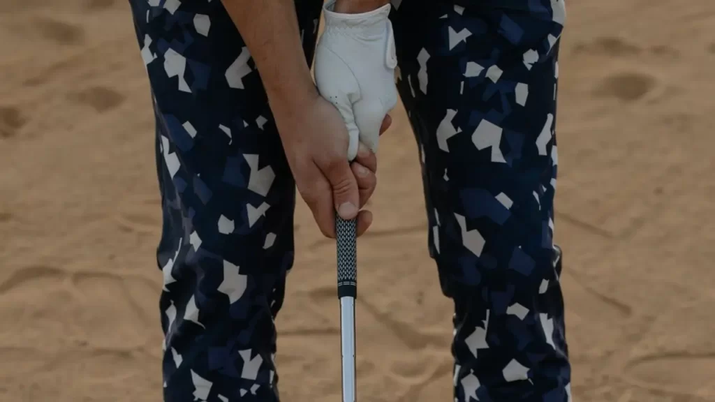 A golfer holding the grip of a golf club