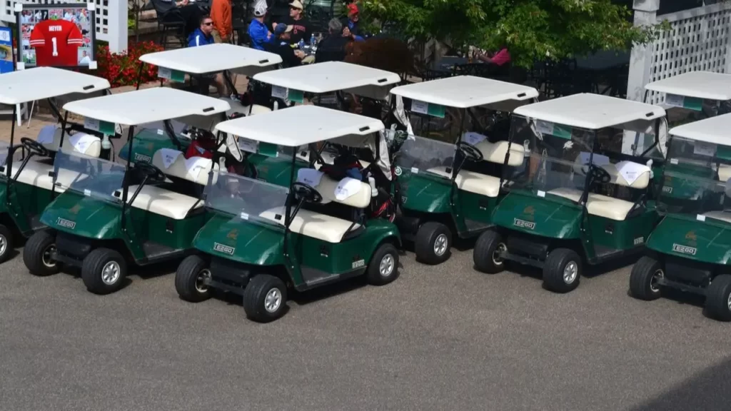Golf carts parked in a parking lot