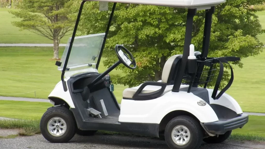 A single golf cart parked on a golf course