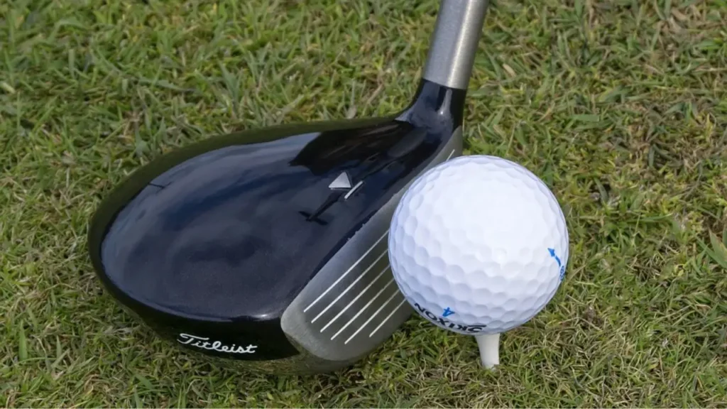 A golf iron hitting a golf ball
