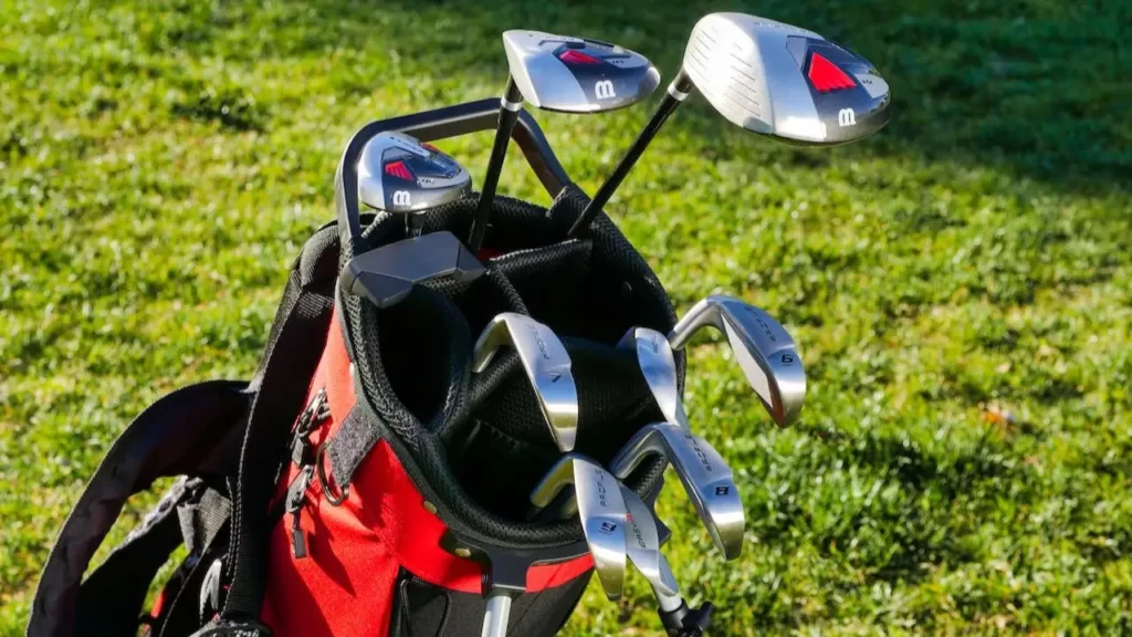 A red golf bag full of golf clubs