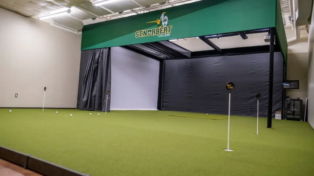 A golf simulator with green astro turn indoors