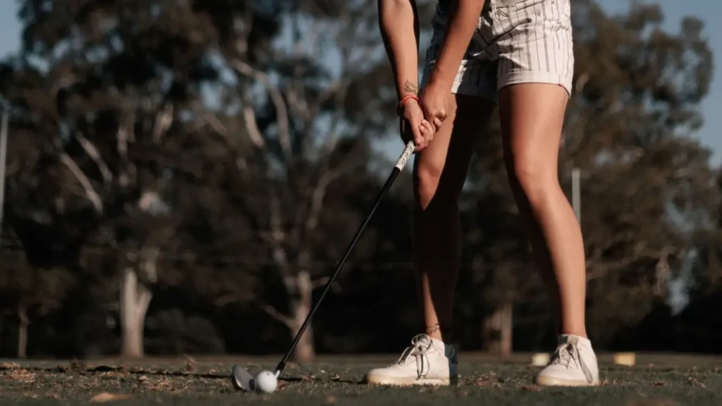 A golfer lining up a shot with a golf club