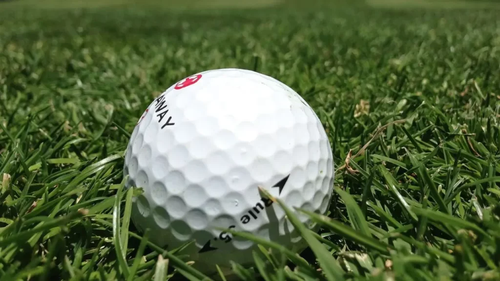 Golf ball on green grass on golf course