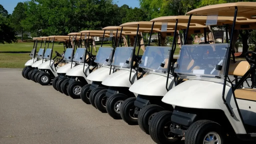A line of golf carts parked at a golf course