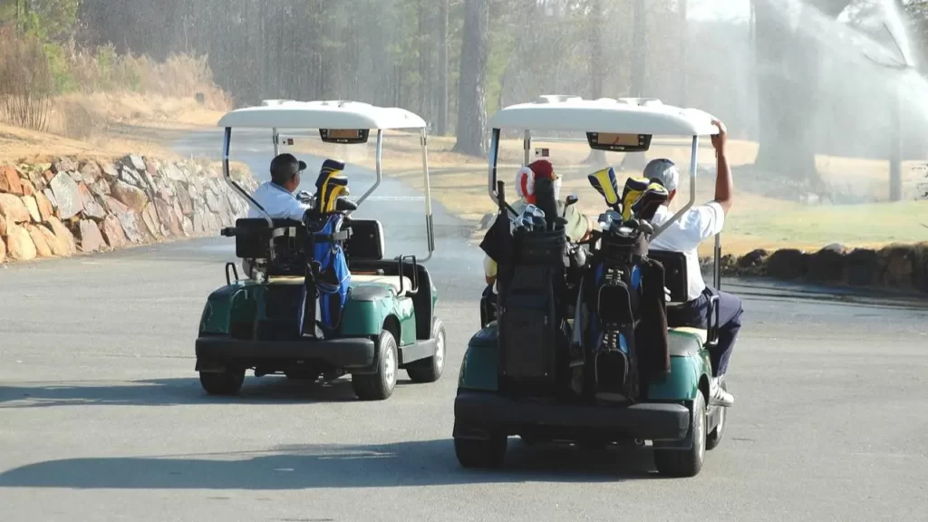Golfer driving golf carts at a golf course