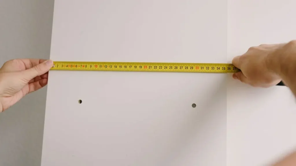 A tape measure measuring against a wall