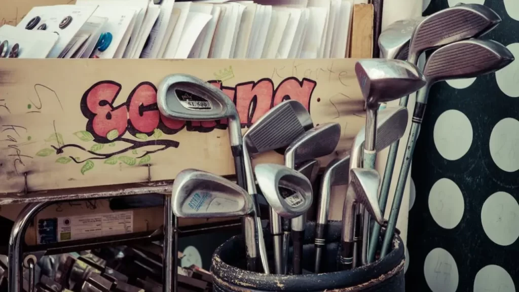A bag full of golf clubs sitting in storage