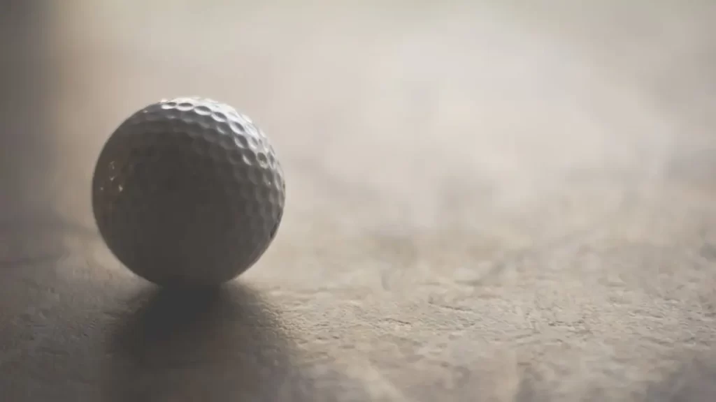 A golf ball sitting on a marle top